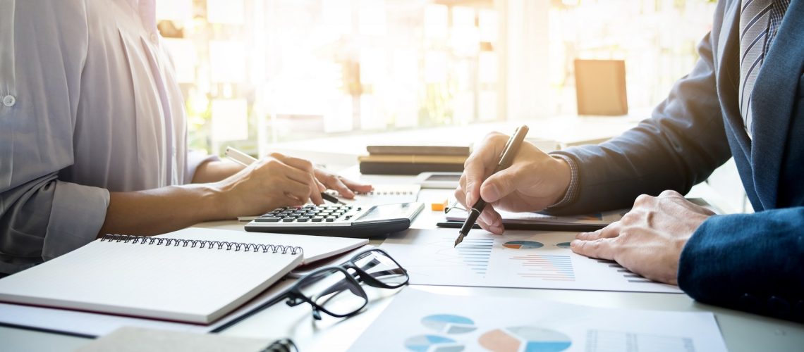 business man financial inspector and secretary making report, ca business man financial inspector and secretary making report, calculating or checking balance. Internal Revenue Service inspector checking document. Audit concept